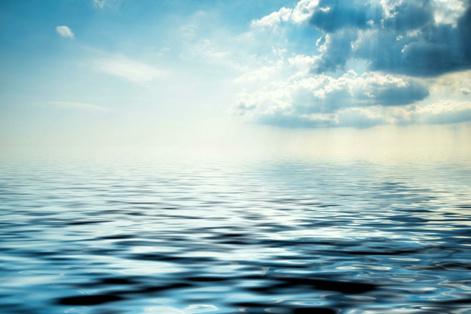 Peaceful ocean view with gentle waves under a partly cloudy sky. Perfect for calming backgrounds.